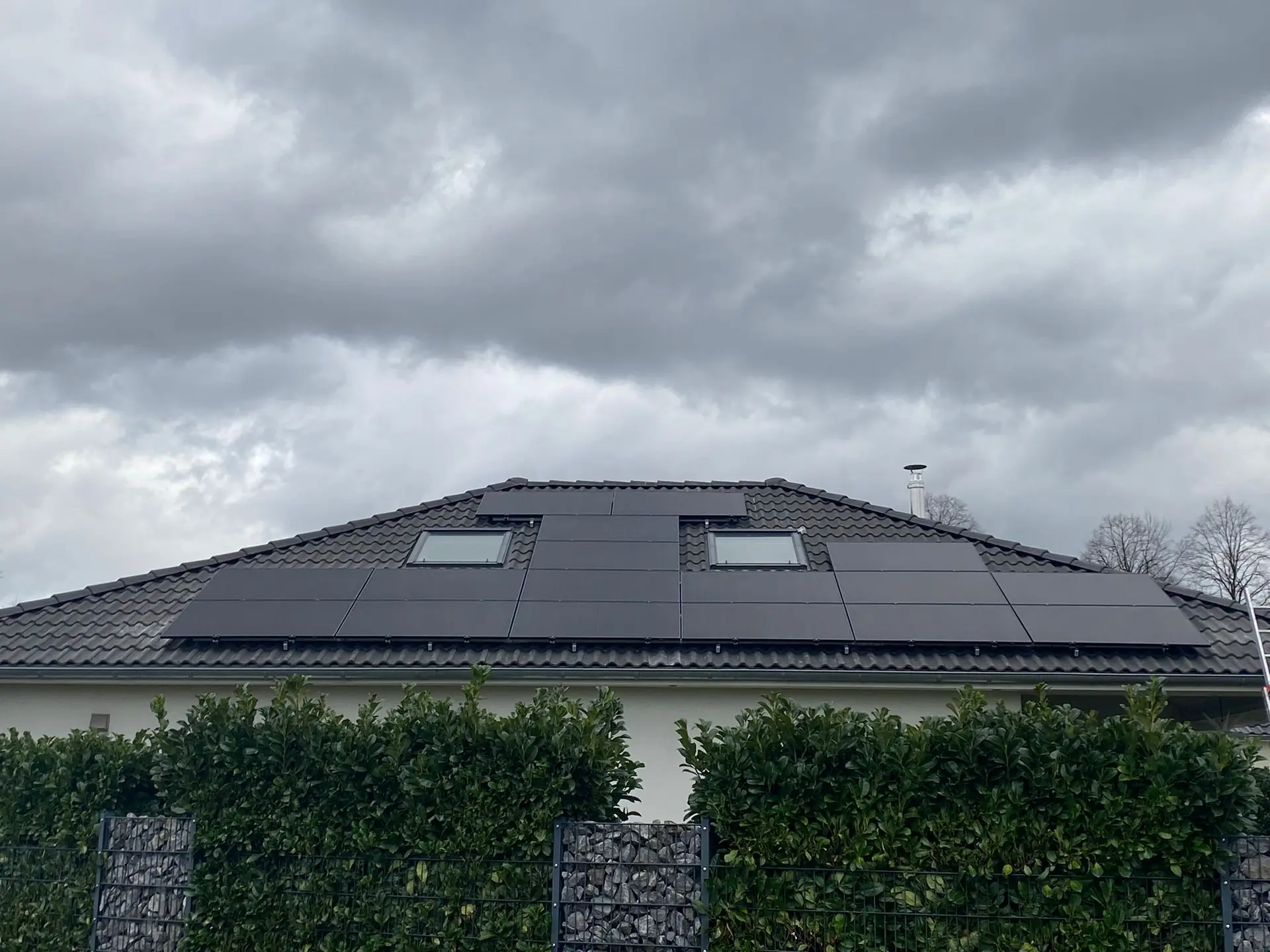 Photovoltaikanlage mit schwarzen Modulen auf einem Bungalow